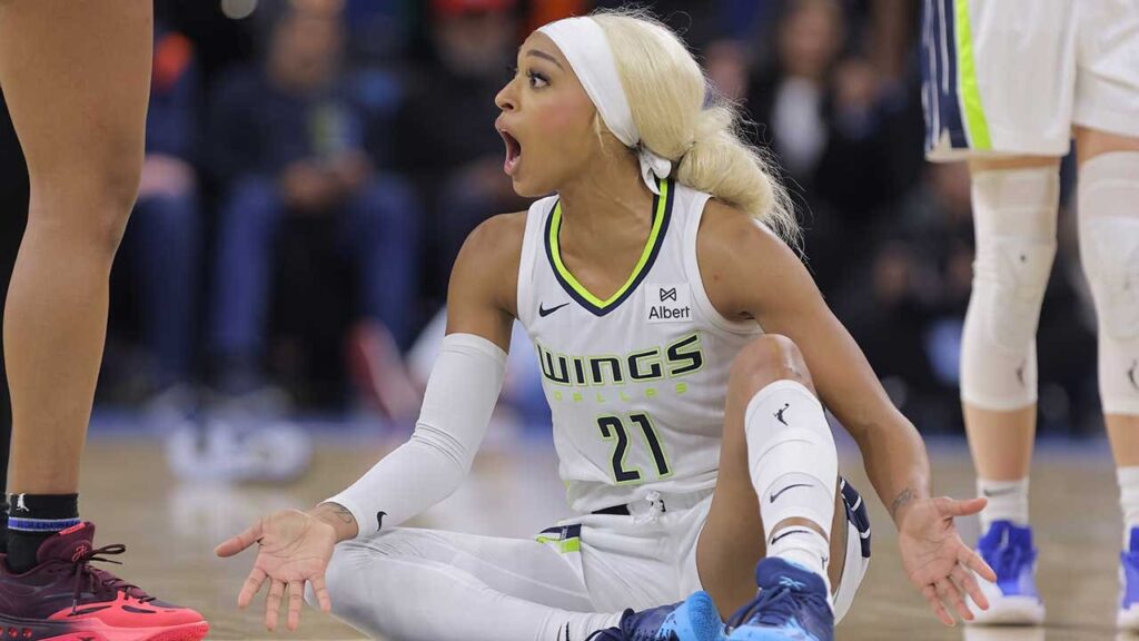 DiJonai Carrington pushes back after referees call security during Wings game