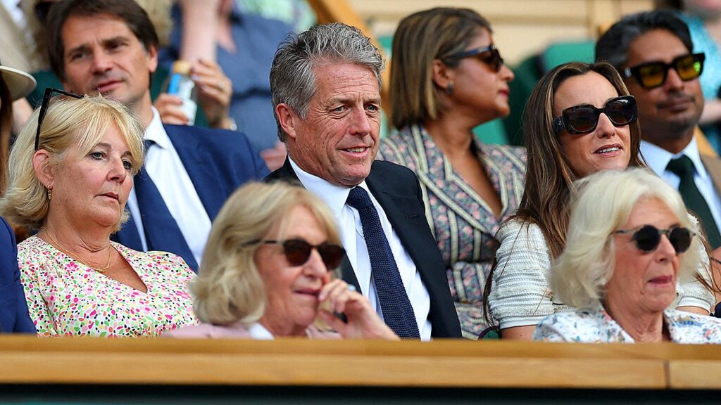 Hugh Grant seemingly takes a nap behind Queen Camilla during Wimbledon